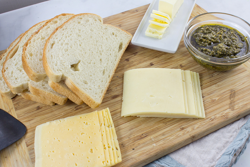 bread, cheese, butter, and pesto to make a grilled cheese with pesto sandwich