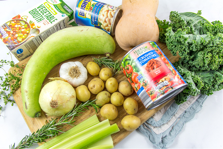 the ingredients to make harvest soup including potatoes, squash, celery, tomatoes, and kaler