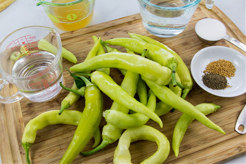 ingredients to make pickled banana peppers including celery seed, mustard seeds, apple cider vinegar, sugar, white vinegar, and water.