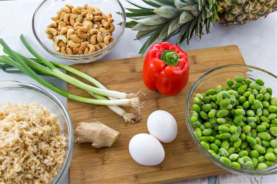ingredients to make vegetarian fried rice including edamame bell pepper and cashews