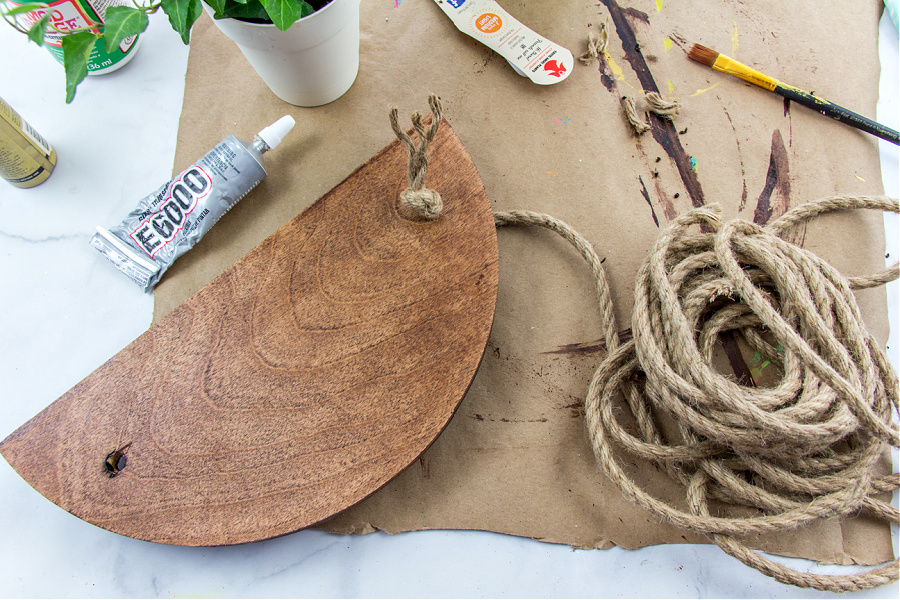 jute rope being tied onto a wood hanging planter