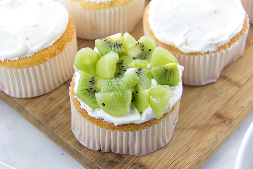 diced green grapes and kiwi fruit on top of mini angel food cakes
