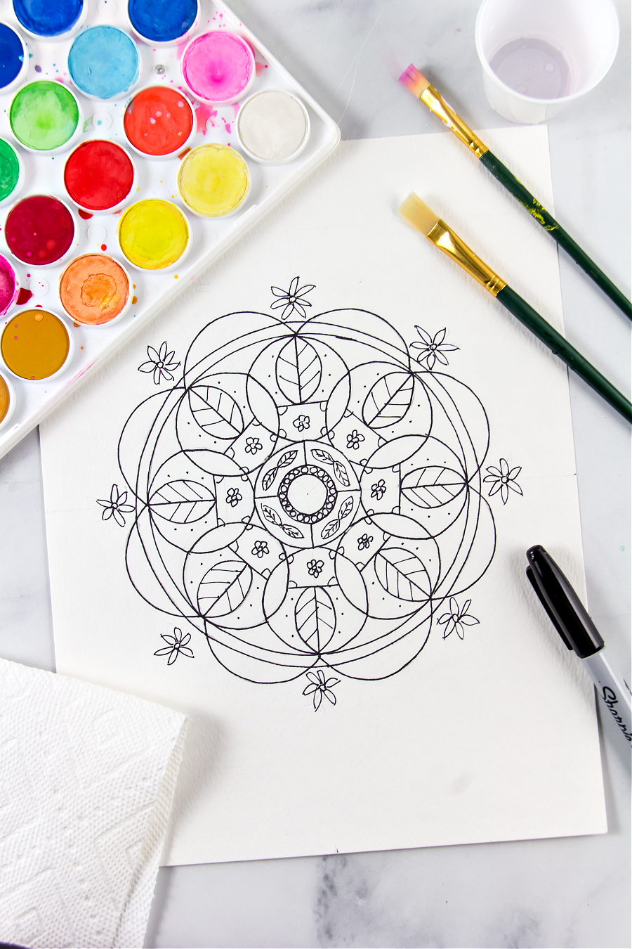 a nature themed mandala design with flowers and leaves