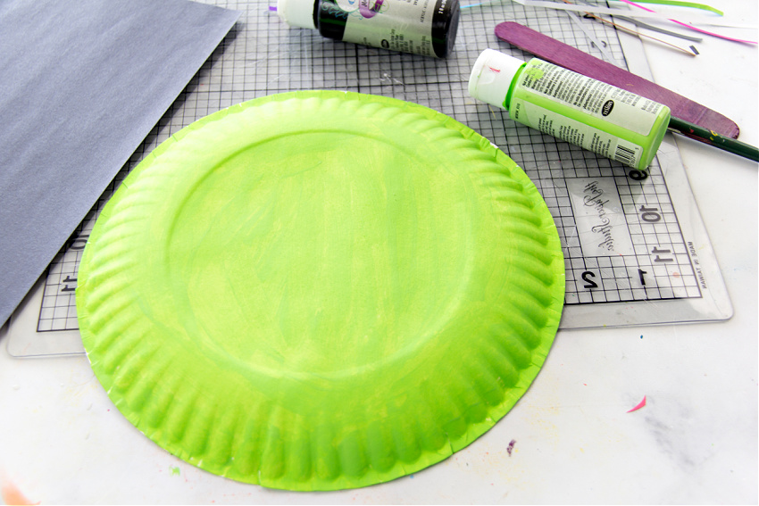 step 1 for making a paper plate witch mask is to paint the paper plate green