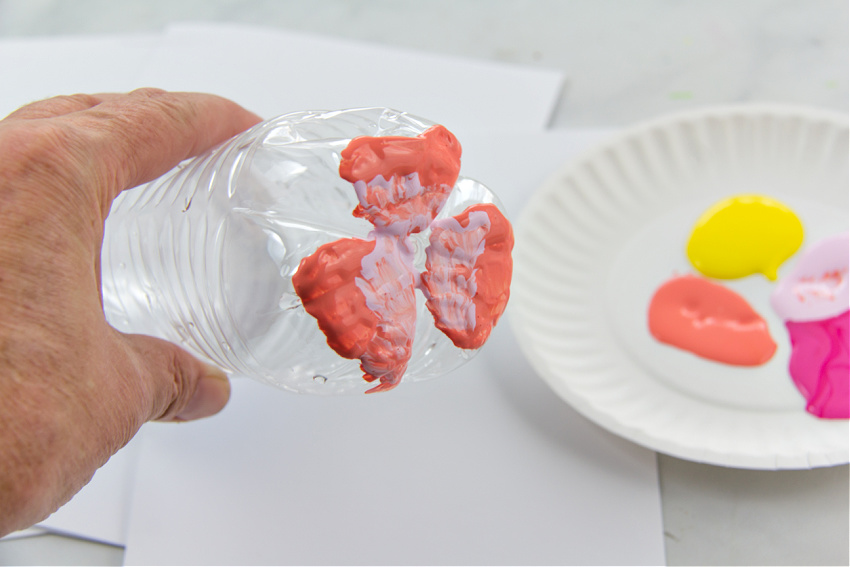 a plastic bottle painted to make a flower