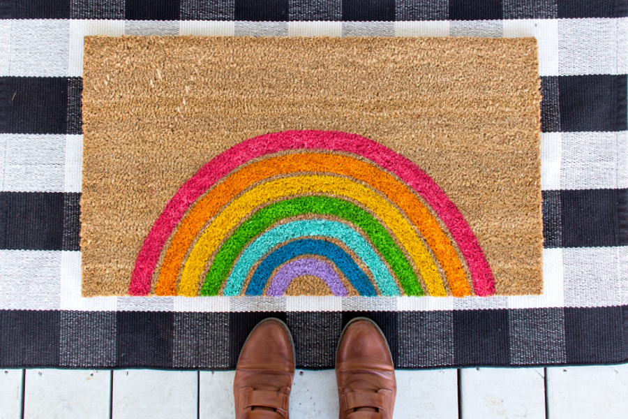 a coir doormat painted with a rainbow
