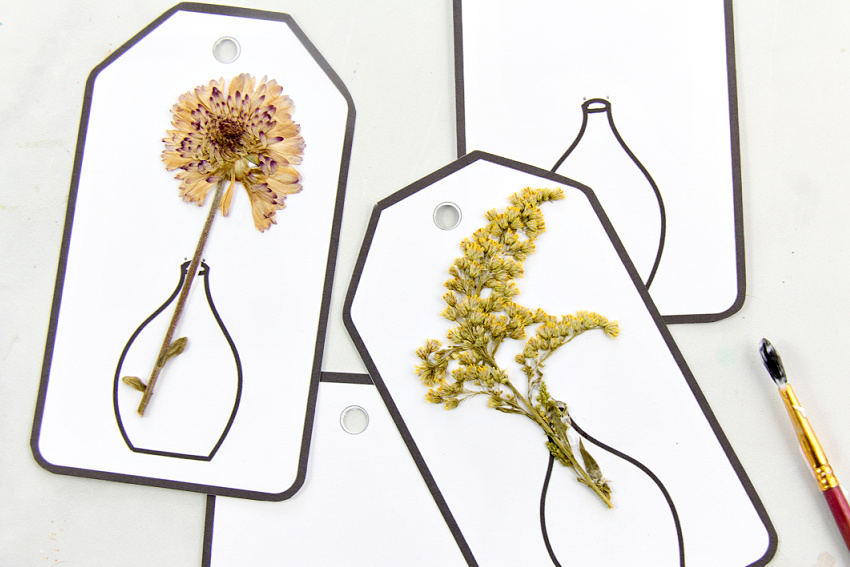 a pressed flower craft using printable gift tags with vases printed on them