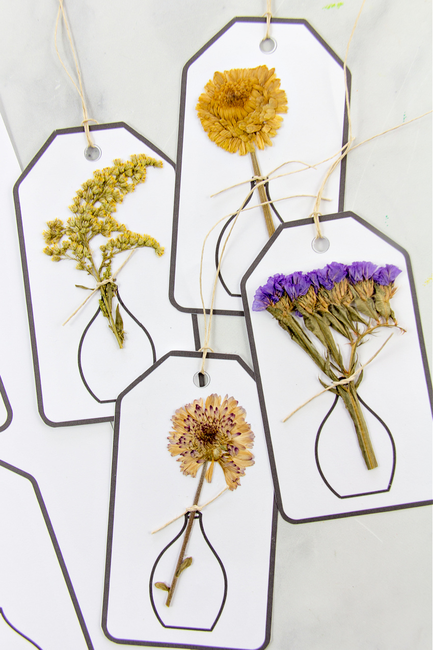 gift tags with pressed flowers attached to them