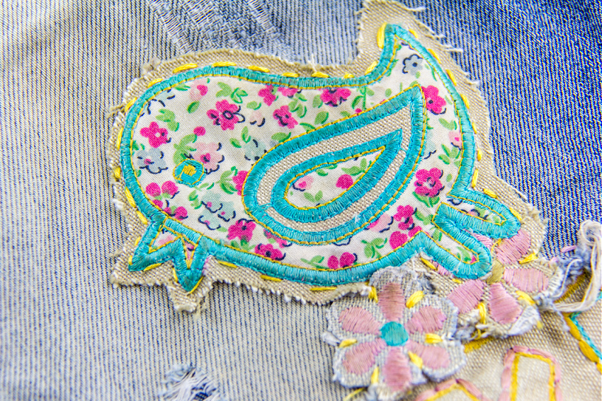 a quilted bird turned into a patch for distressed jeans