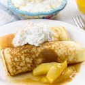 pancakes rolled and filled with apple cinnamon compote and topped with whipped cream and salted caramel maple syrup