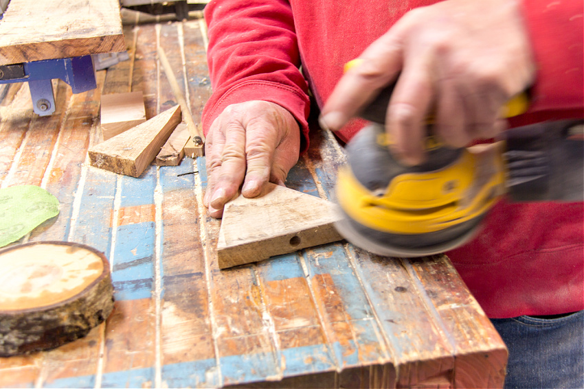 man sanding triangle woodworking trees for kids