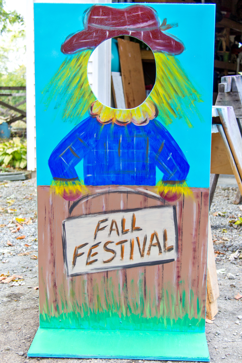 a diy scarecrow photo booth board for a fall festival