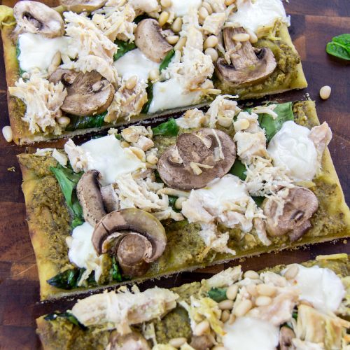 pesto chicken flatbread pizza with mozzarella spinach and mushrooms