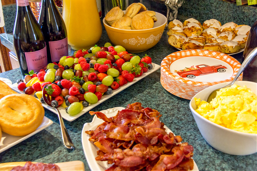 side dishes for a bag bar including fresh fruit, scrambled eggs, and bacon