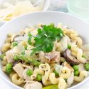 pasta dinner with asparagus, grilled chicken, mushrooms, and peas