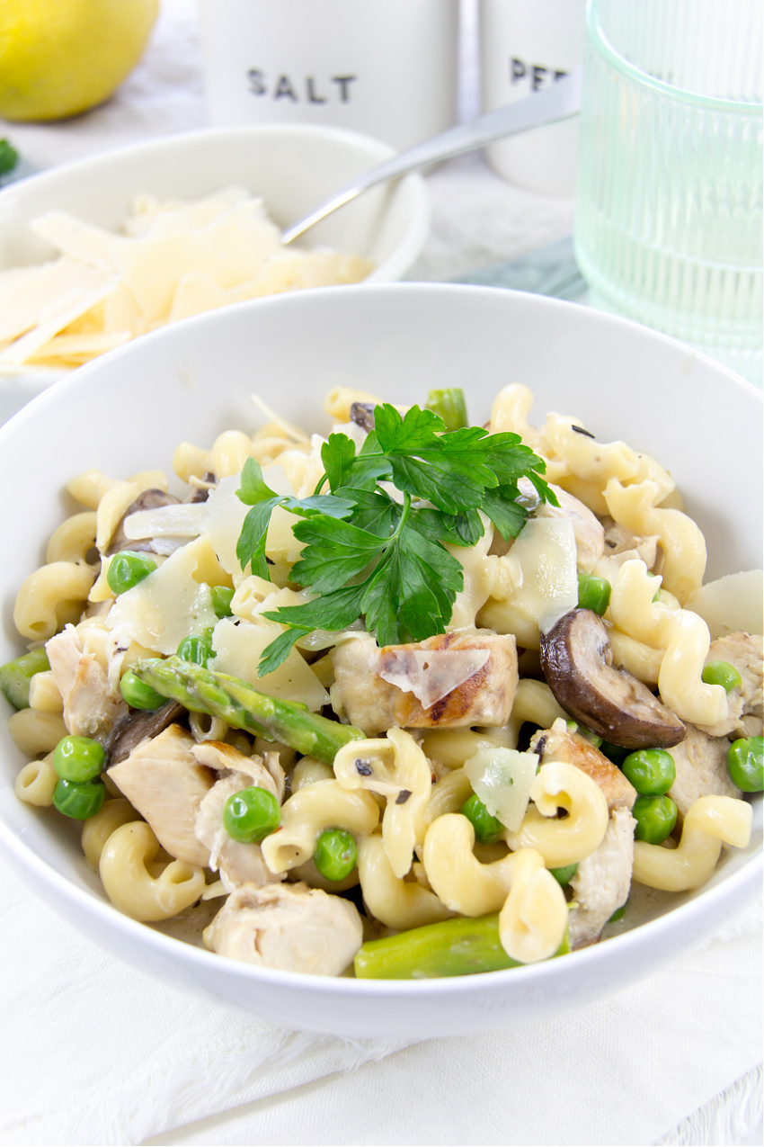 pasta dinner with asparagus, grilled chicken, mushrooms, and peas