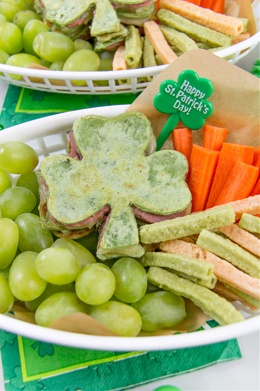 st patricks day food tray with a shamrock quesadilla with grapes, vegetable chips and carrot sticks
