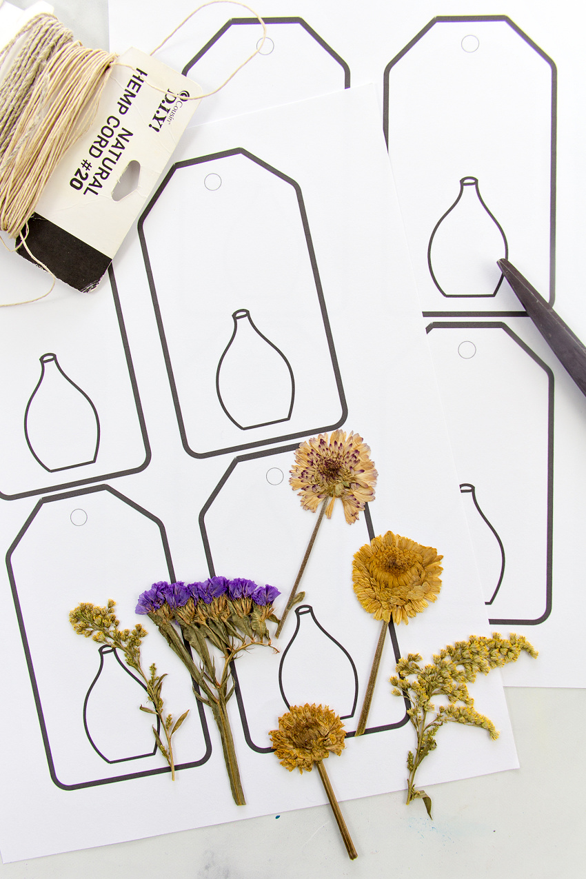 free printable gift tags with a vase on them, pressed flowers, and twine to make gift tags