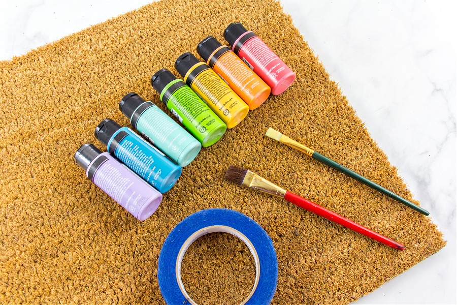 paint and a coir mat to make a rainbow doormat
