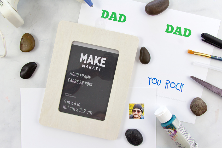 you need a wood frame, paint, rocks, and a photo to make a dad rocks frame craft