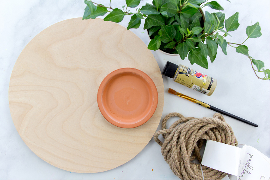 birch wood circle, terracotta saucer and jute rope to make an indoor hanging planter