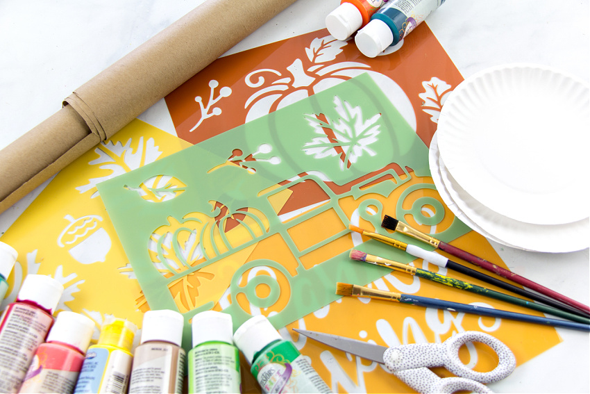 stencils, brown paper, and paint for kids to make fall placemats