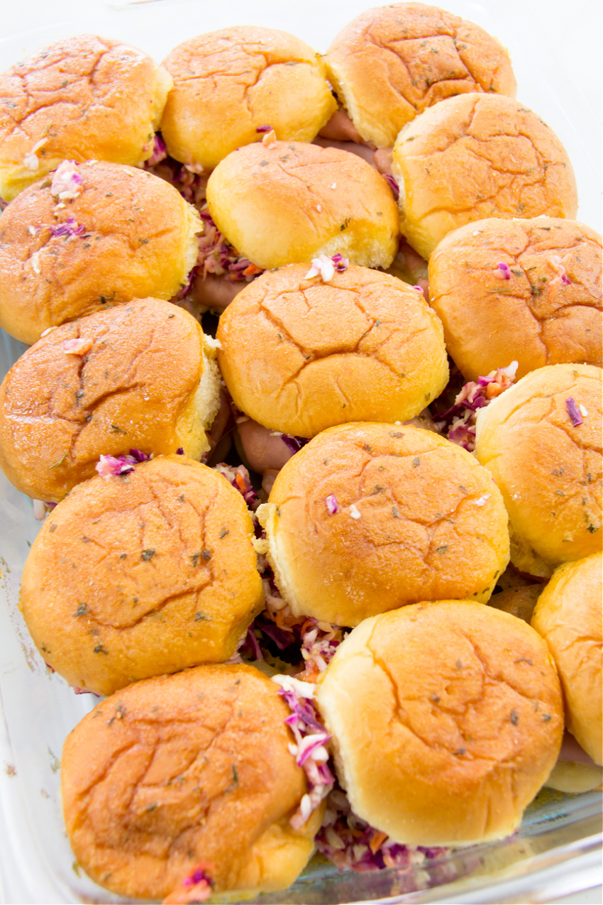 turkey and cheese sliders topped with mango coleslaw