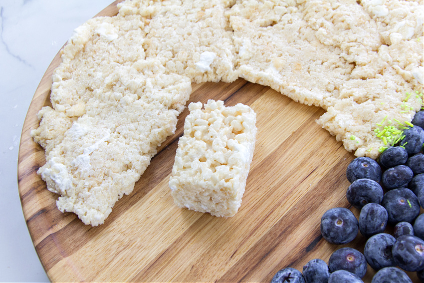 Rice Krispies treats being rolled out to make sand for an ocean themed party food tray