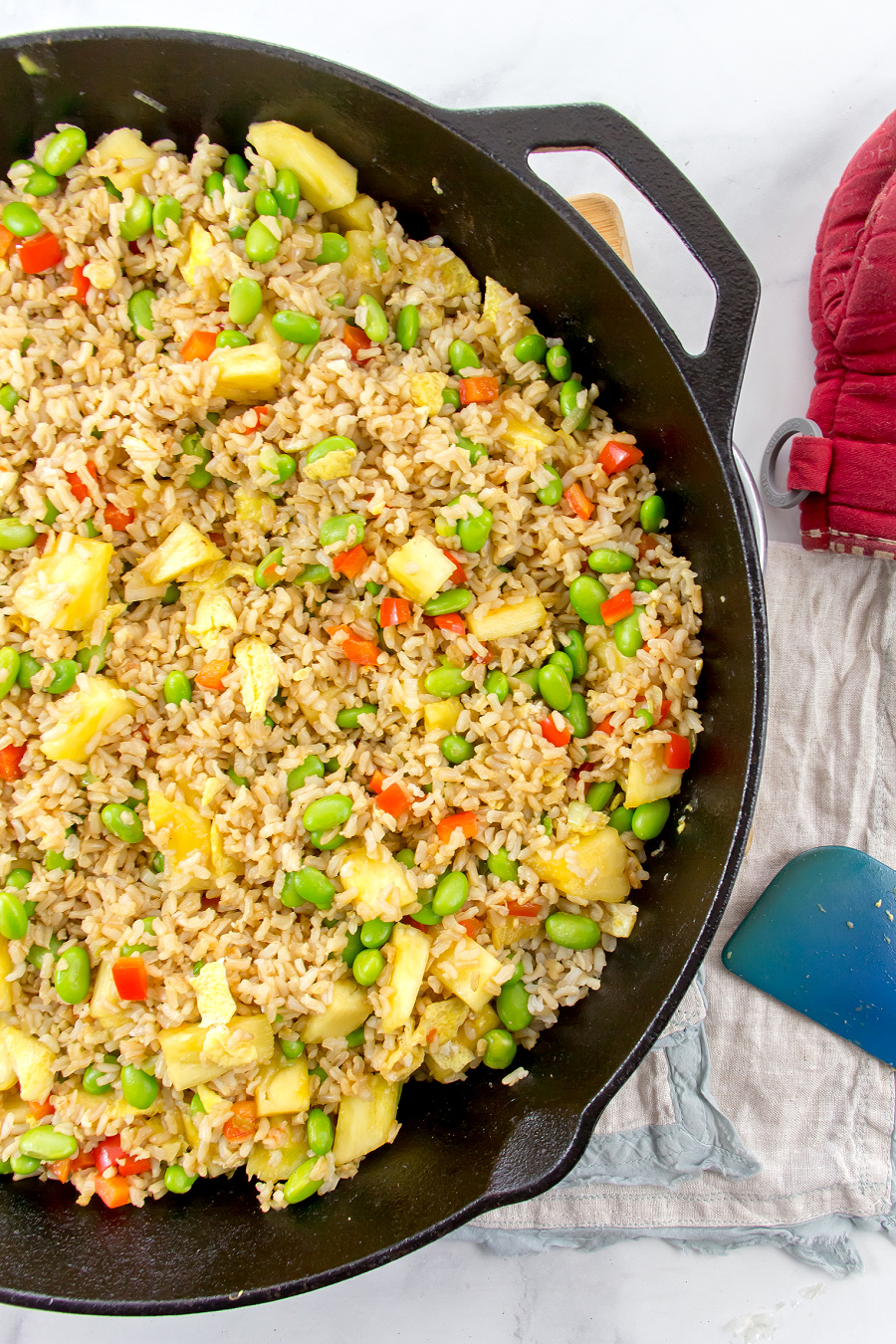 pineapple cashew vegetarian fried rice being cooked in a cast iron skillet