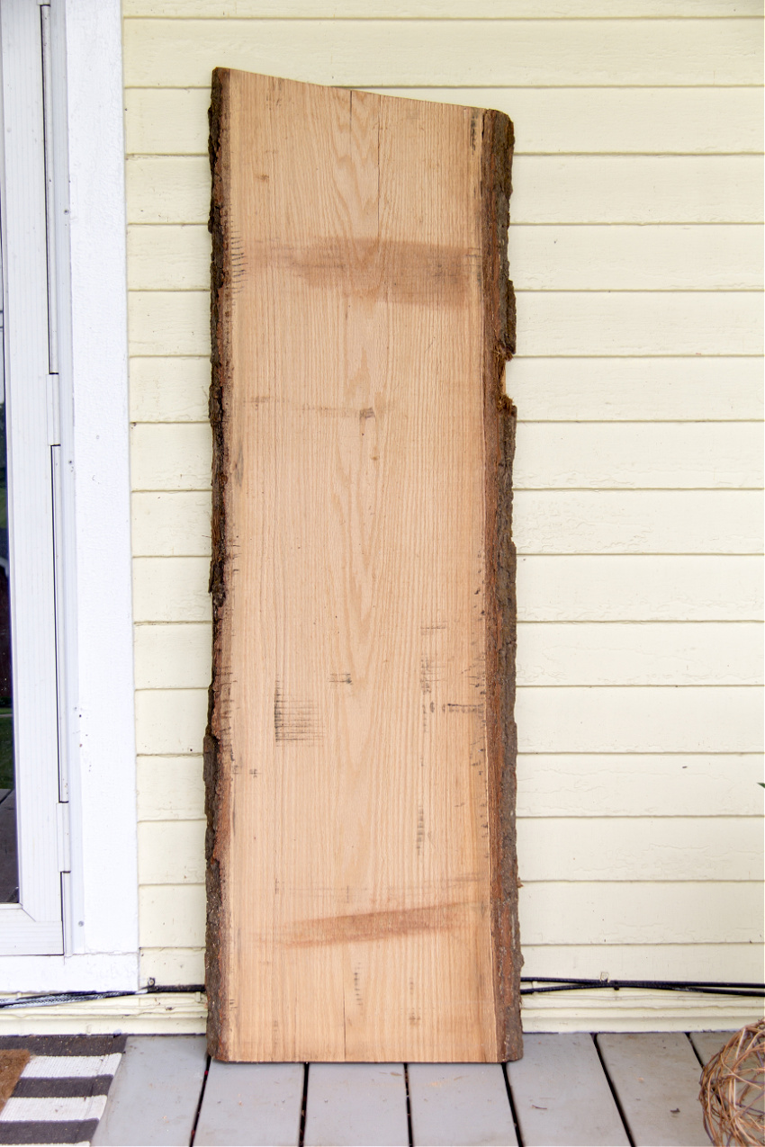 white oak wood slice being used as a porch sign