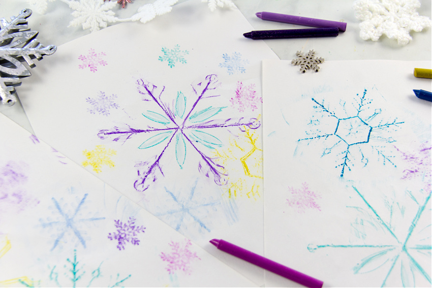 crayon rubbing art using snowflake ornaments for winter art for kids