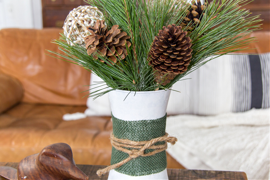 christmas tree branches, pinecones and branch balls in a winter painted vase